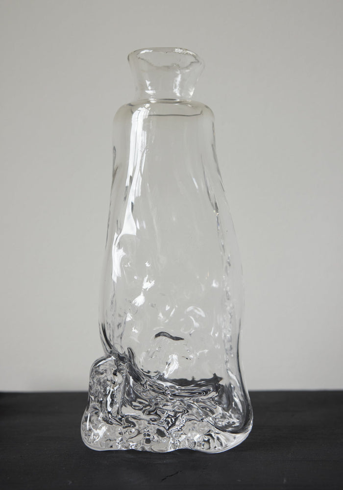 Blown vase | Glass: Hand-blown clear glass vase with an organic, melting form, showcasing Szkło Studio's unique, functional art approach by Aleksandra and Wojciech Zawistowski.