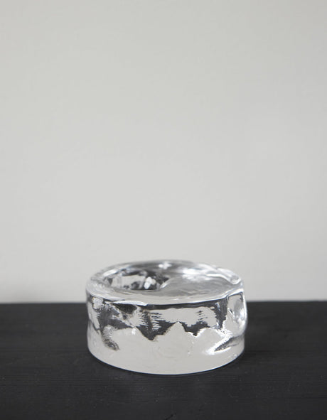 Presse-papier & holder | Glass: A single white egg stands on a transparent glass block, showcasing Szkło Studio's unique hand-blown craftsmanship and experimental design.