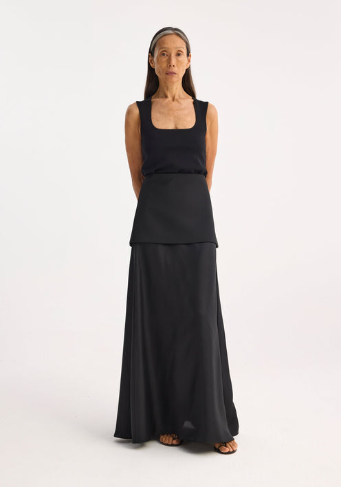 Woman wearing a Bustier shaped knitted top with a fitted, square neckline, and layered panels, paired with a flowing skirt. Model height: 1.72m, size EU 36.