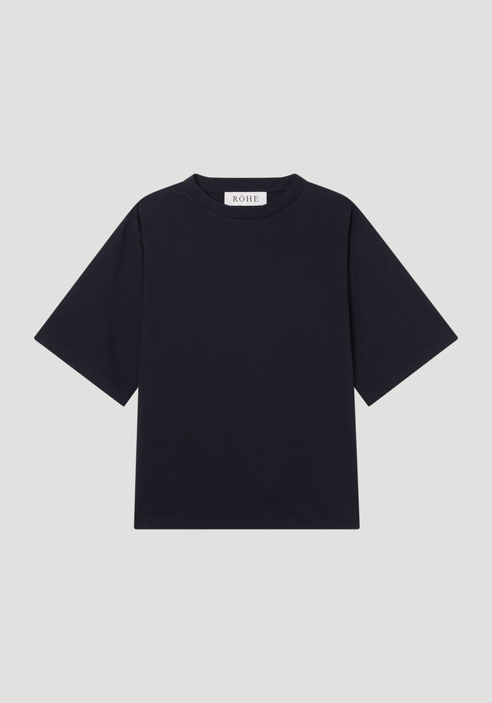 Oversized cotton t-shirt by RÓHE, featuring a plain black design with crew neck, short sleeves, and brand label at the collar, laid flat.