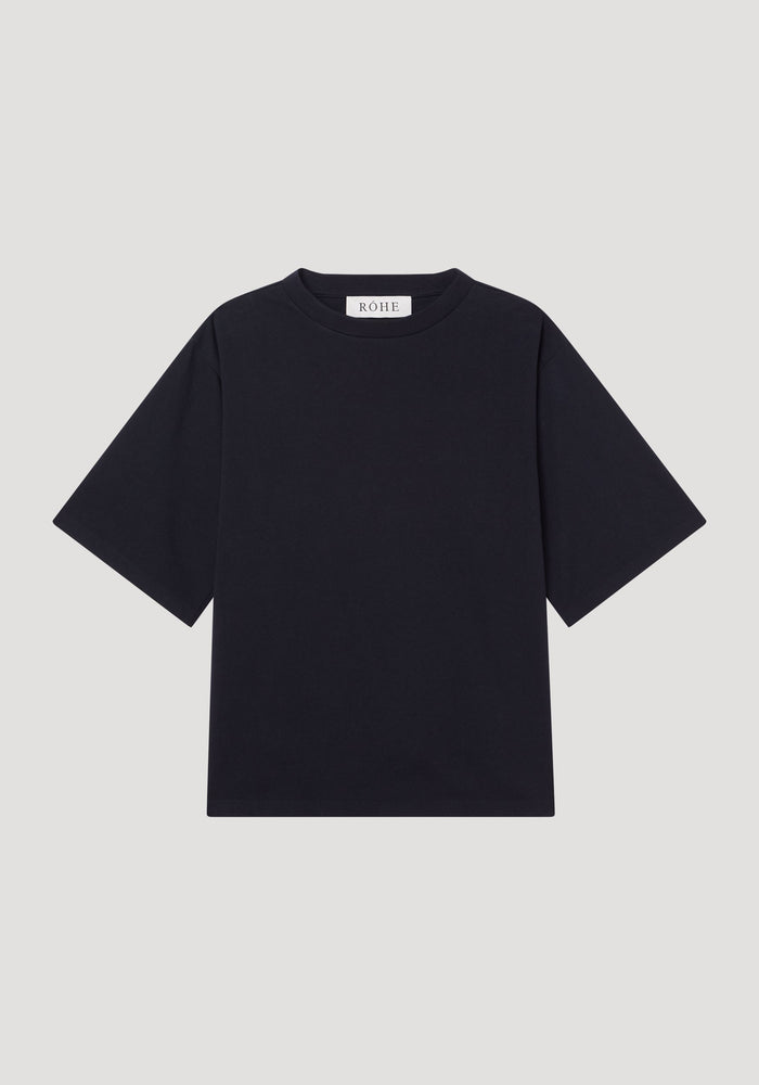 Oversized cotton t-shirt in black, featuring a boxy fit, crew neck, drop shoulders, and a small RÓHE label at the back neckline. Made from organic cotton.