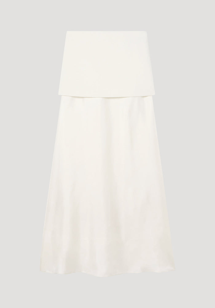 Integrated fluid silk skirt in cream, featuring a strapless bandeau top, high waist, flared silhouette, and blind side seam zip, combining wool and silk textures.