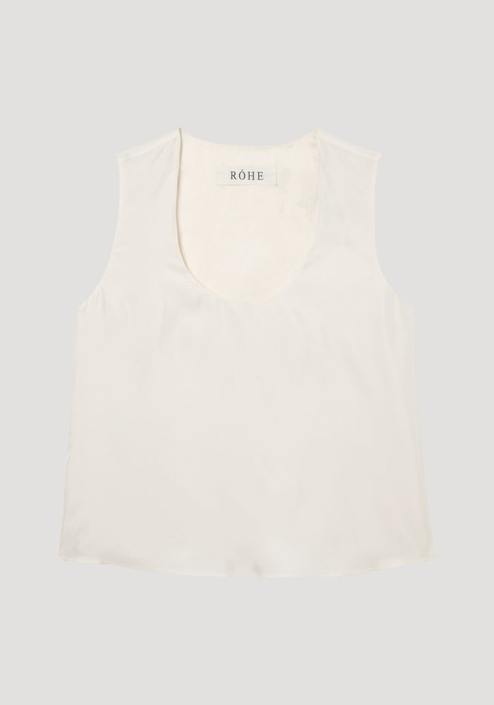 Scoop-neck silk top in cream, featuring a wide scooped neckline, sleeveless design, and loose fit. Made from 100% silk with a minimalist aesthetic.