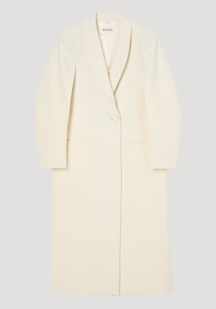Signature opera coat | ivory, features a full-length, single-button design with a shawl collar, tailored fit, center back slit, and welt pockets.