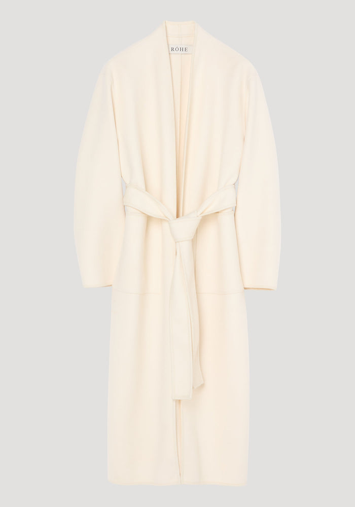 Double-faced kimono style coat in off white, featuring a calf-length wrap design with patch pockets, long sleeves, and a self-tie belt for an adjustable fit.