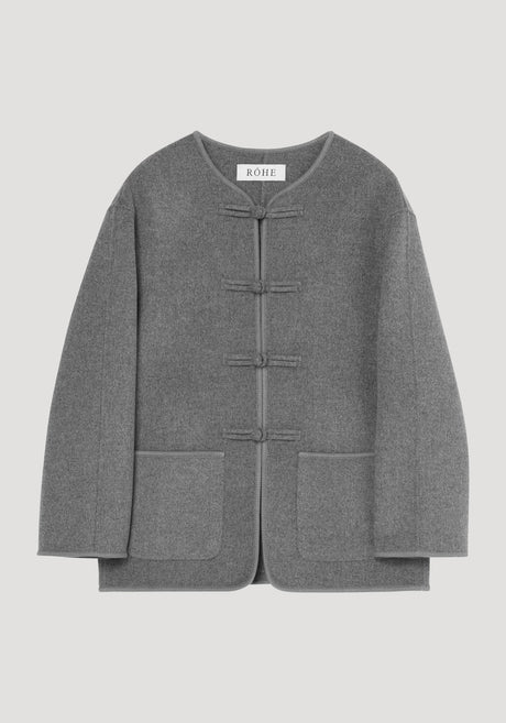 Mandarin double-faced wool jacket in mid grey melange with four frog closures, embroidered edges, patch pockets, and a simple rounded neckline, labeled RÓHE.