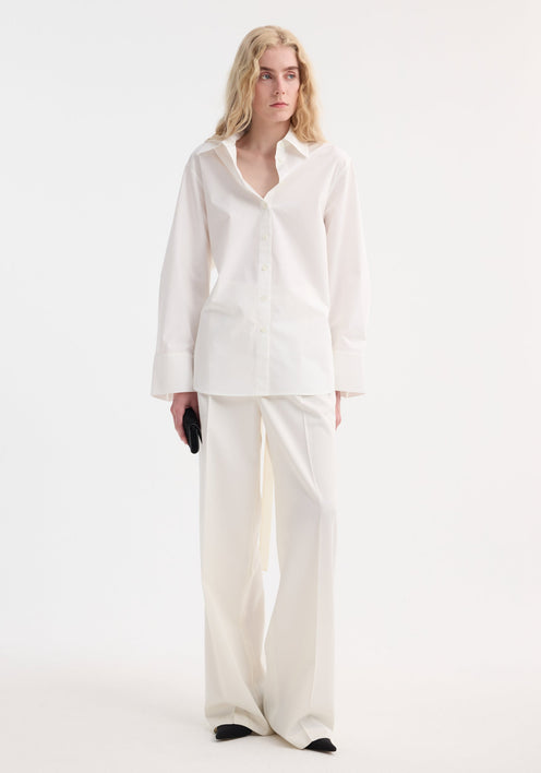 Poplin silk combined gilet-shirt by RÖHE, featuring a button-down front, collared neckline, long sleeves knotted at waist, and silk back with open armholes.