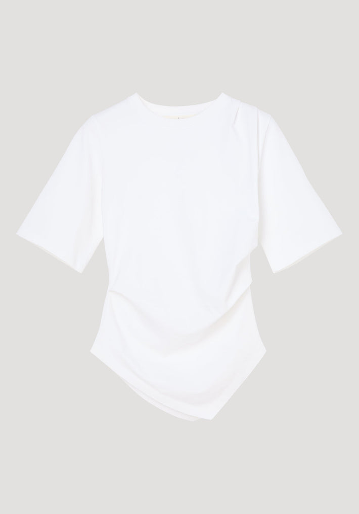Reinvented twisted t-shirt in optic white, featuring a twisted asymmetrical drape, fitted waist, elbow-length sleeves, crafted from 100% organic cotton.