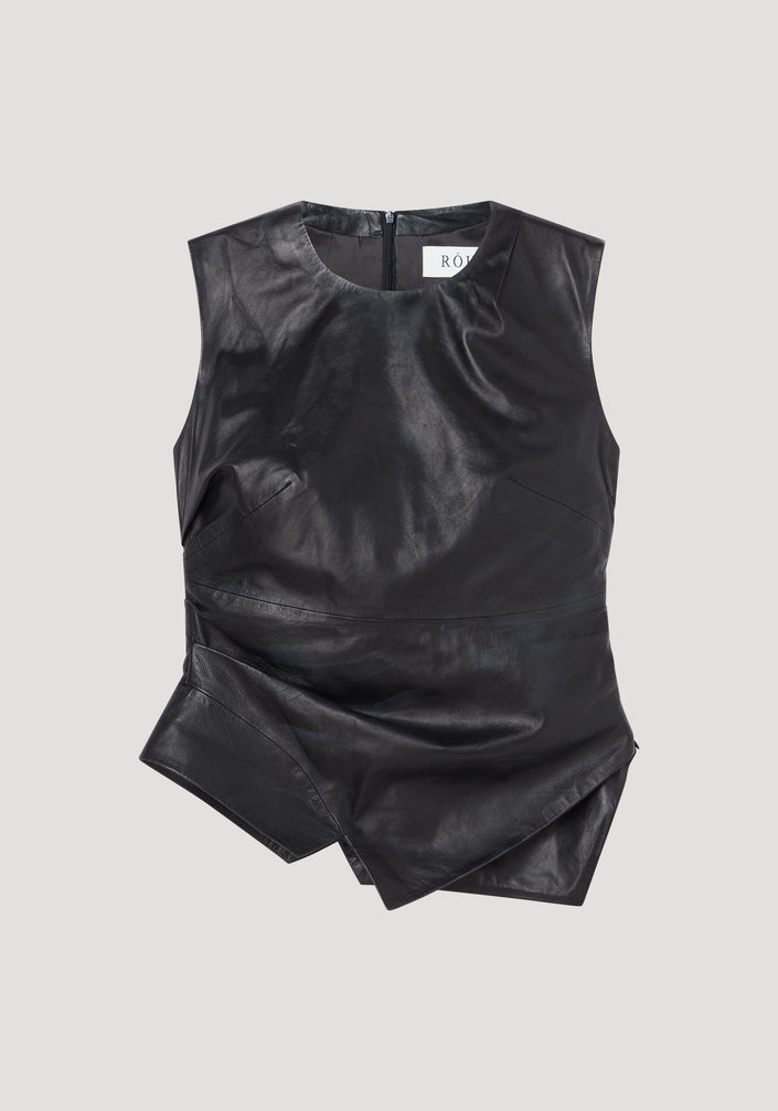 Sleeveless draped leather top in black with asymmetric layered hem, rounded neckline, fitted waist, and center-back zipper, offering a modern elegant silhouette.