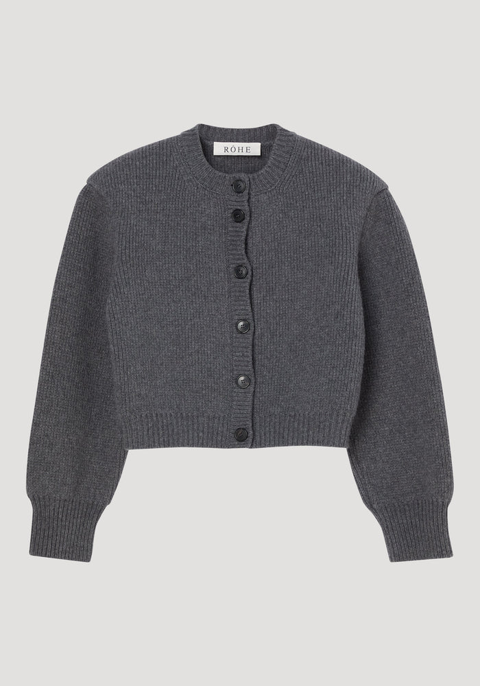 Statement shoulder cardigan in charcoal-gray rib knit, featuring a round neckline, long sleeves, oversized fit, and six black buttons. Made in Italy from 100% wool.