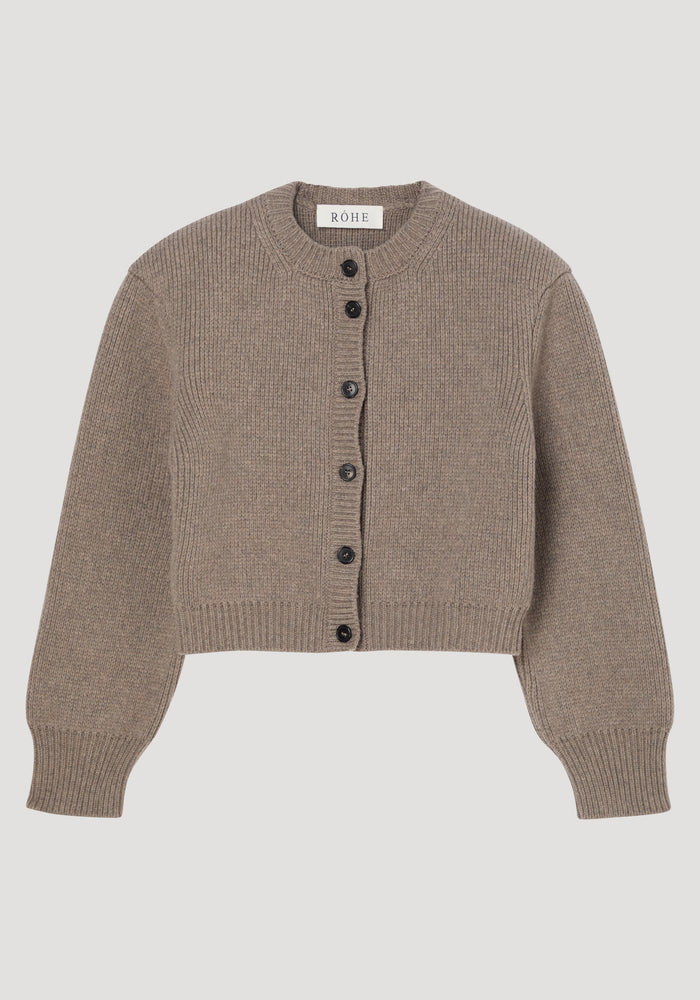 Statement shoulder cardigan in clay melange, featuring a ribbed knit, oversized fit, sculptural shoulders, dark button closure, and round neckline. Crafted from Italian pure wool.