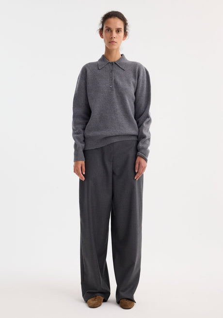 Compact knitted polo in mid grey melange, featuring a long-sleeve design, pointed collar, four-button placket, and ribbed cuffs, crafted from Italian wool-cashmere blend.