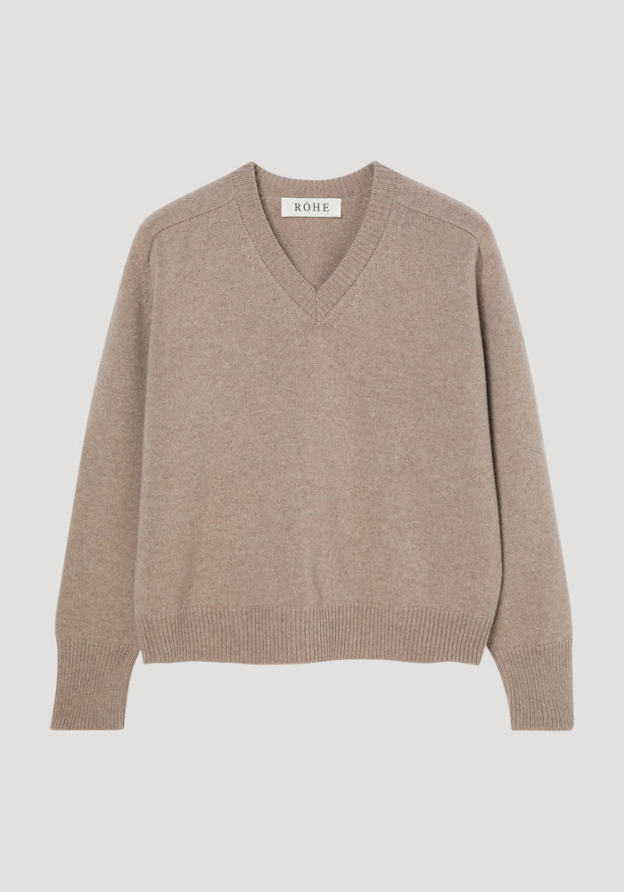 Sleeve wrap jumper in taupe melange, showing V-neck, ribbed cuffs and hem, relaxed fit. Crafted from a cashmere-wool blend, features twistable sleeves for versatile styling.