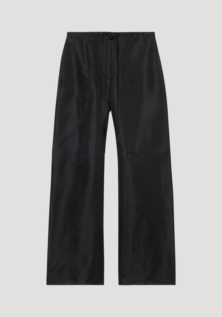 Organza silk parachute trousers in black, featuring a wide-leg design and drawstring waist, crafted from sheer, flowing silk organza for elegant movement.