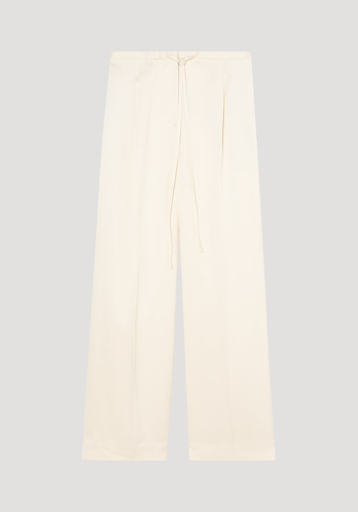 Relaxed drawstring satin trousers in cream, featuring wide-leg design, drawstring waistband, front pleats, and back welt pockets, made from 100% viscose satin.