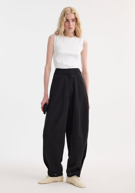 Parachute trousers | black: High-waisted, wide-leg trousers in lightweight viscose-linen. Features concealed fly, slanted pockets, adjustable ankle tabs, and a brand label at the waistband.