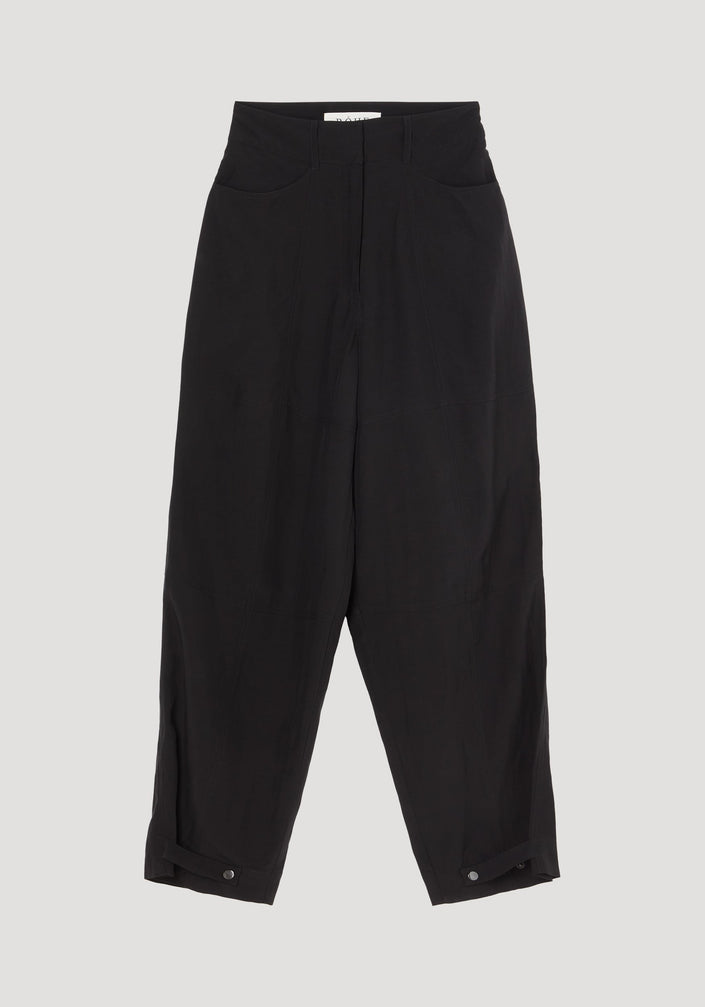 Parachute trousers | black: High-waisted, wide-leg trousers in lightweight viscose-linen. Features concealed fly, slanted pockets, adjustable ankle tabs, and a brand label at the waistband.
