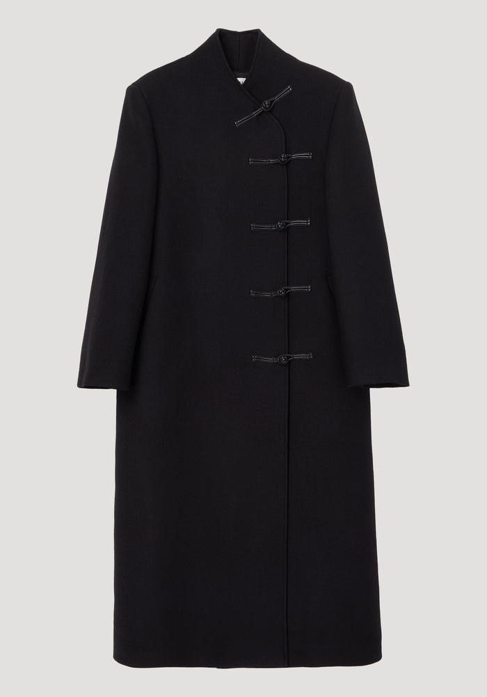 Mandarin wool coat in black featuring asymmetric mandarin closures, long length, side pockets, crafted from 100% virgin wool with a minimalist, straight silhouette.