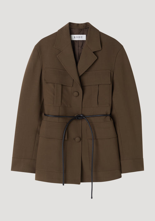 Safari blazer-jacket in deep olive-brown with notched lapel, four flap pockets, black tie-belt, and covered buttons; crafted from 100% virgin wool for a relaxed fit.