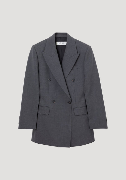 Hourglass blazer in dark grey melange with peak lapels, six buttons, flap pockets, and a cinched waist, showcasing a structured, feminine silhouette.