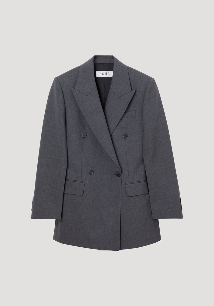 Hourglass blazer in dark grey melange with peak lapels, six buttons, flap pockets, and a cinched waist, showcasing a structured, feminine silhouette.
