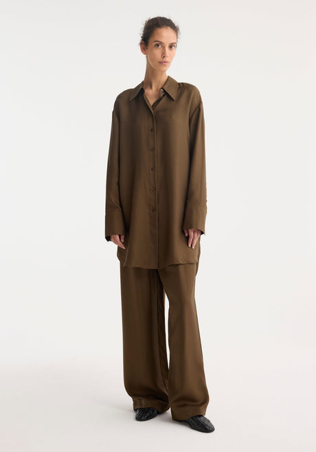 Signature elongated silk shirt | forest, featuring a rich chocolate-brown hue, oversized fit, pointed collar, button-down front, and simple cuffs. Crafted from 100% silk for elegance.