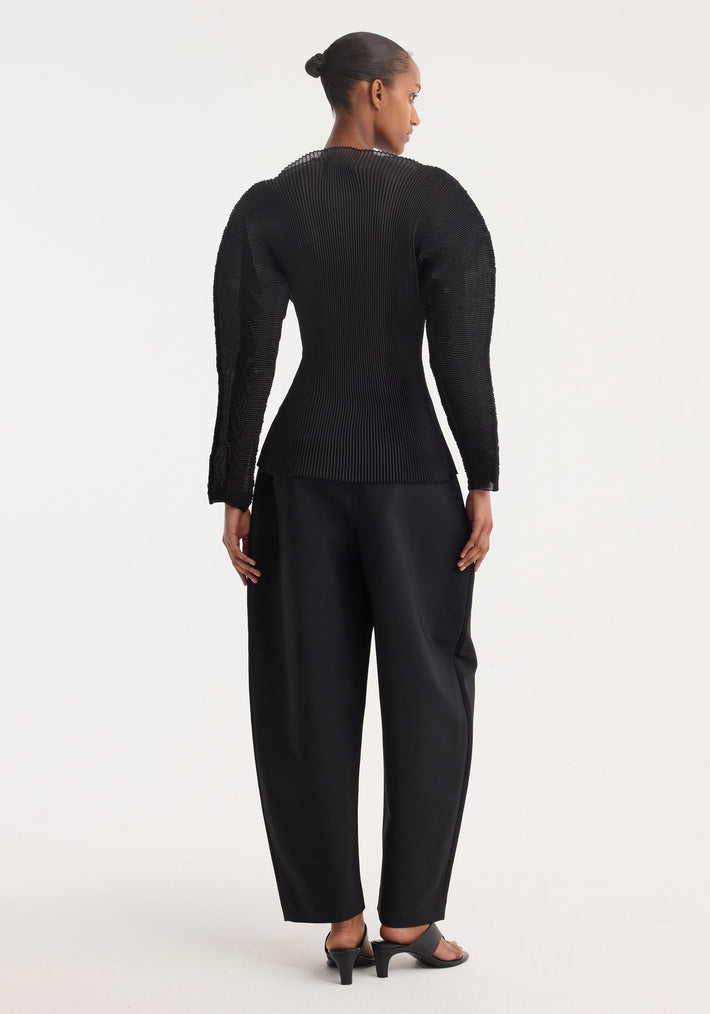 Model wearing Sculptural plissé top | black, featuring voluminous, pleated sleeves and a flared waist, paired with high-waisted trousers and open-toe heeled sandals.