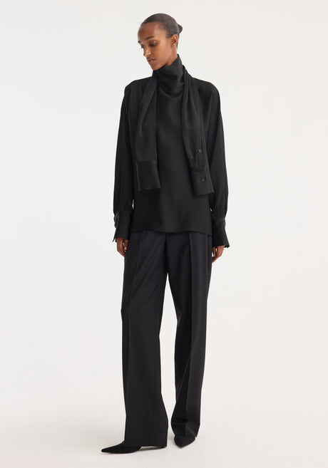 Foulard satin top in black with draped sleeves and scarf-like neckline, showcasing a fluid silhouette in soft satin, laid flat against a neutral background.