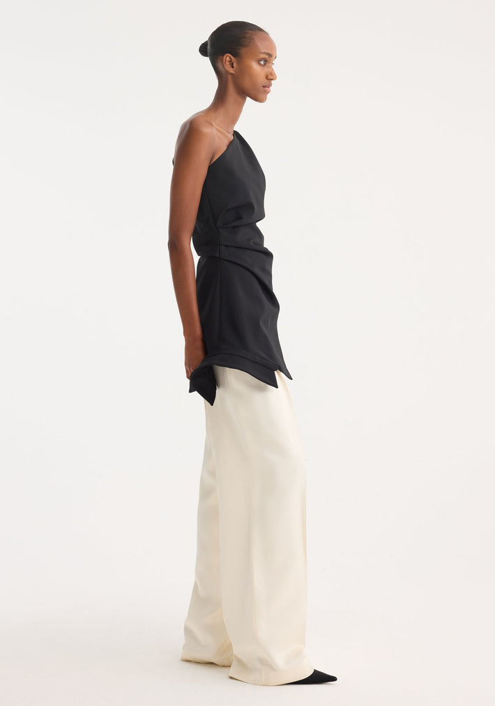 Reimagined one shoulder top | black, featuring an asymmetrical design with a deconstructed shirt collar, worn by a model with wide-leg trousers.