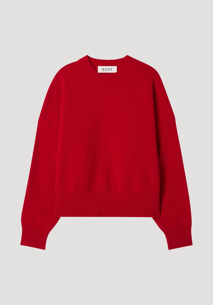 Boiled wool crewneck | rosso: Plain red, long-sleeved crewneck sweater with relaxed fit, drop shoulders, crafted in superfine wool, displayed flat with a RÔHE neck tag.