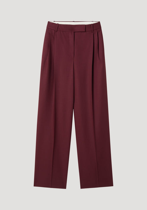 Mid-waist tailored trousers in burgundy, featuring a straight-leg cut with belt loops, a concealed front closure, and subtle pleats, made from 100% virgin wool.
