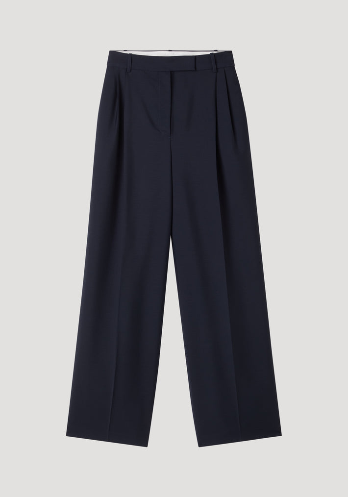 Mid-waist tailored trousers in navy, featuring a wide-leg design with double pleats and belt loops, crafted from a wool-mohair blend for structure and breathability.