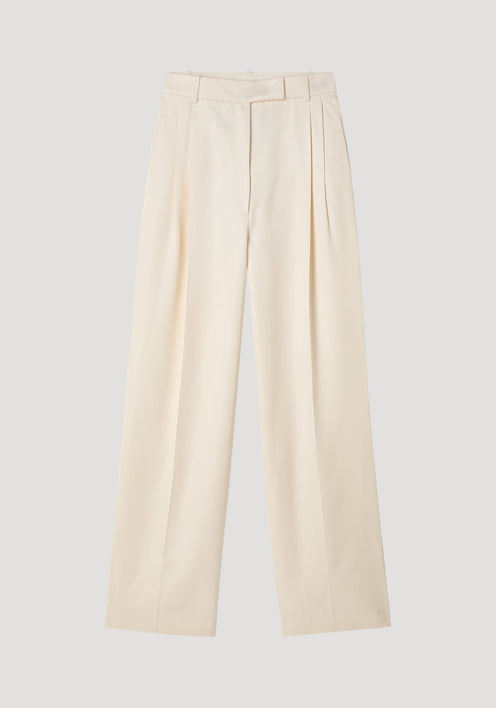 High-waist satin trousers in cream with a tailored waistband, front and back pleats, and welt pockets, laid flat on a neutral background.