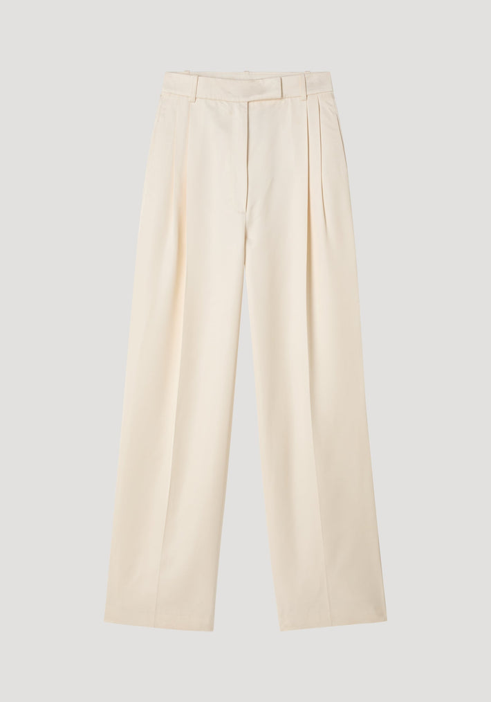 High-waist satin trousers in cream with a tailored waistband, front and back pleats, and welt pockets, laid flat on a neutral background.