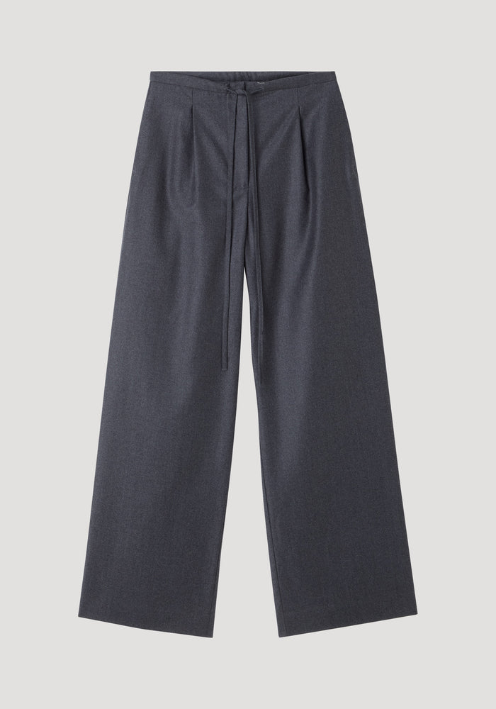 Relaxed soft wool trousers in dark grey melange, featuring a wide-leg, cropped style with a drawstring waistband, made from lightweight virgin wool for comfort.