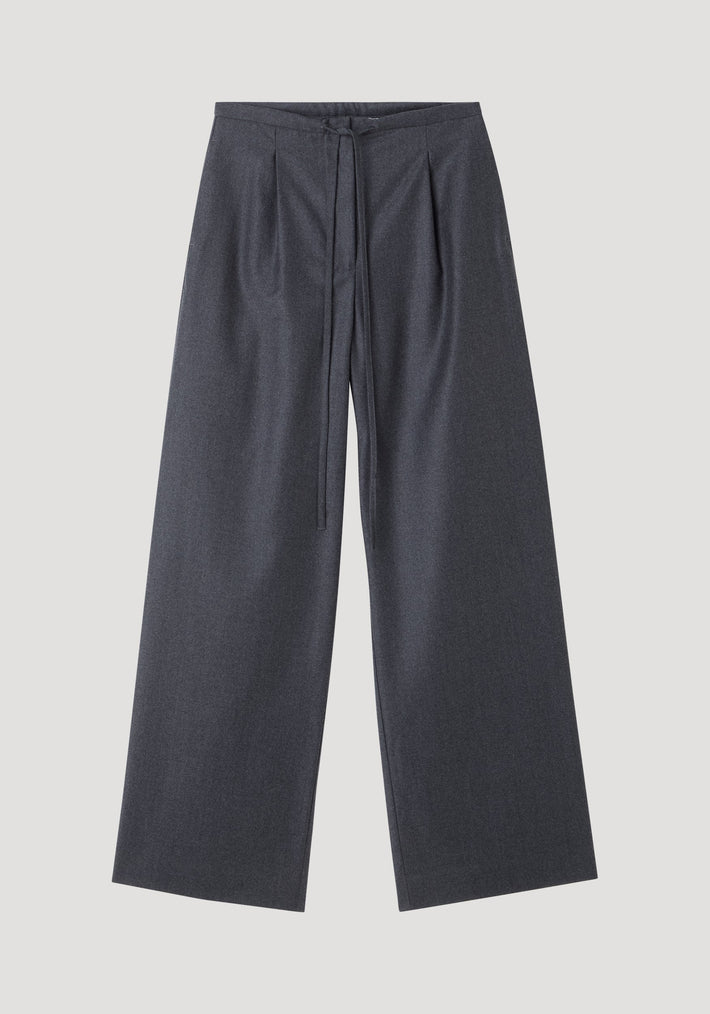 Relaxed soft wool trousers in dark grey melange, featuring wide-leg silhouette, high waist with drawstring, subtle pleats, and slanted pockets, crafted from lightweight virgin wool.