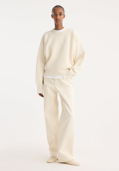 Compact cotton trousers in off-white, featuring a wide-leg, low-waist design. Includes button and zip closure, side pockets, and belt loops for a minimalist look.