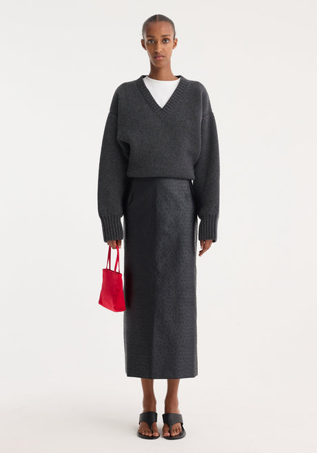 Ostrich satin column skirt | black, featuring a mid-calf length, straight tailored fit, and embossed ostrich-skin texture with waist dart seams for shaping.