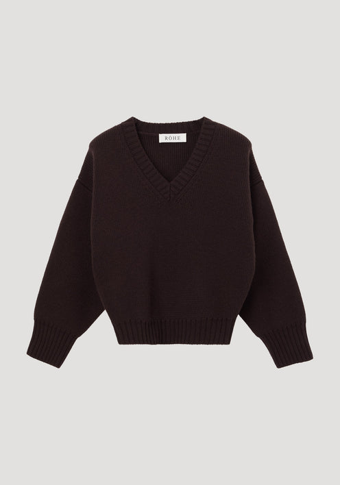 Sculptural compact V-neck dark brown sweater with long sleeves, ribbed cuffs, and hem, featuring a RÖHE label at the neckline. Expertly knitted from soft wool.