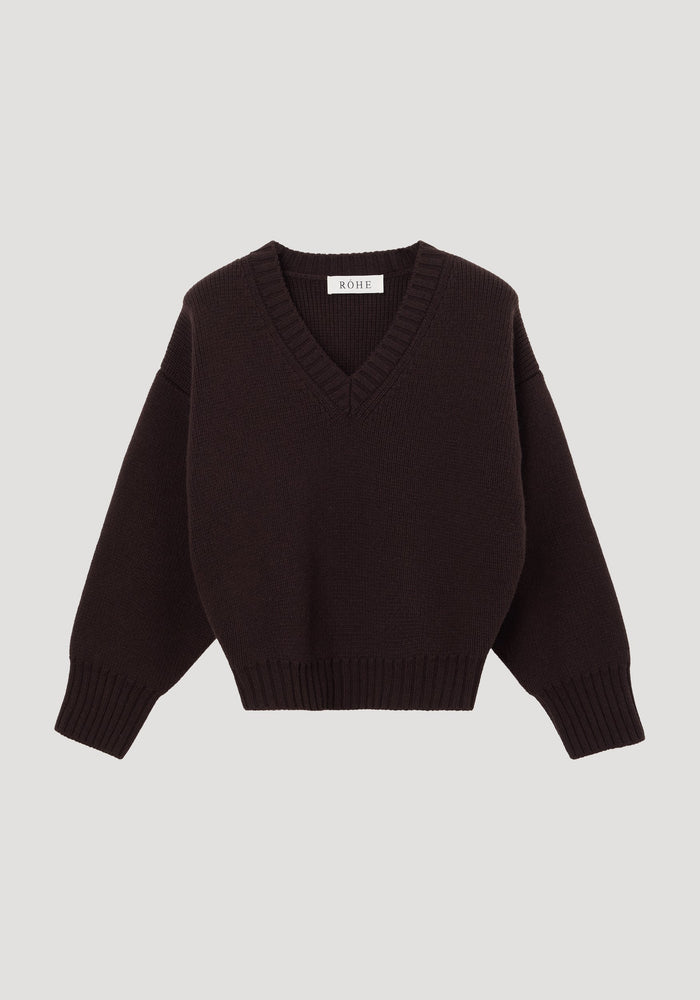 Sculptural compact V-neck dark brown sweater with long sleeves, ribbed cuffs, and hem, featuring a RÖHE label at the neckline. Expertly knitted from soft wool.