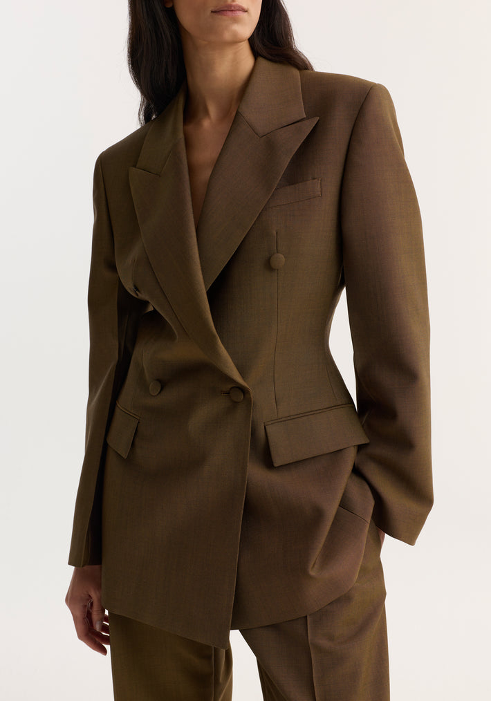 Hourglass blazer in golden brown featuring a double-breasted design, wide peaked lapels, covered buttons, and matching trousers, creating a structured, feminine silhouette.