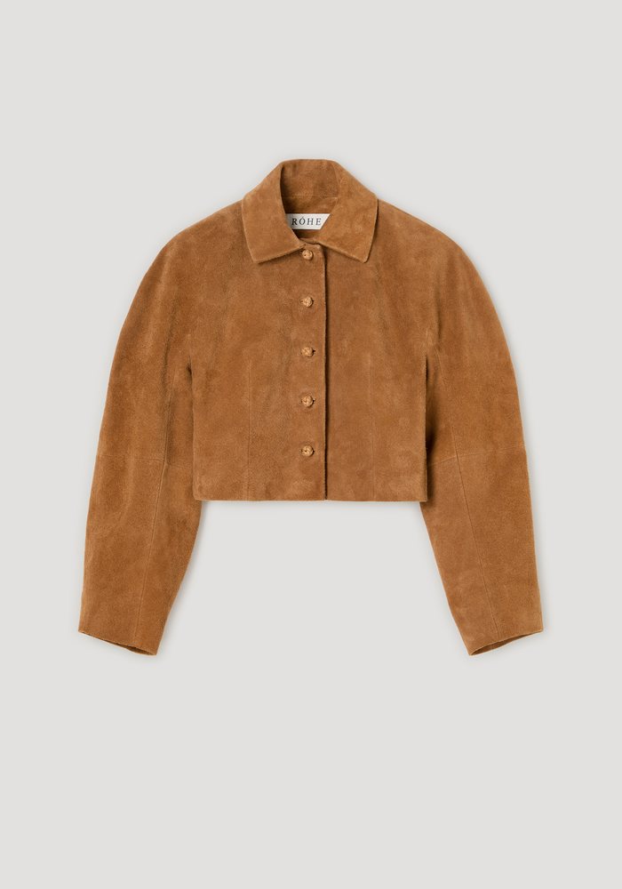 Rounded textured suede jacket | cognac: A cropped, button-up tan suede jacket with a boxy cut, pointed collar, knotted buttons, and softly structured sleeves.