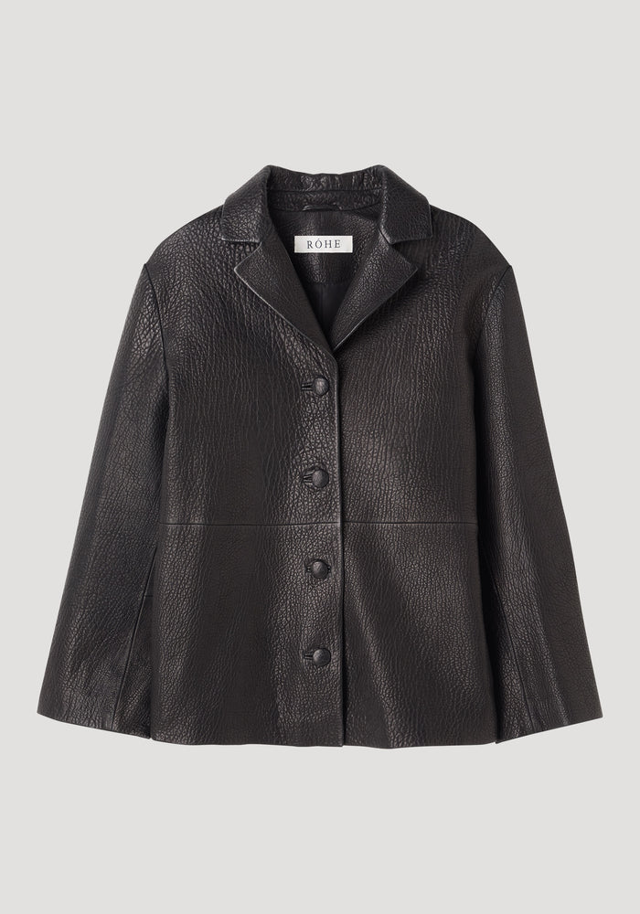 Leather jacket with small lapel in black, featuring a notch collar, four buttons, flared hem, and side-seam pockets, crafted from heavy-grain lamb leather.