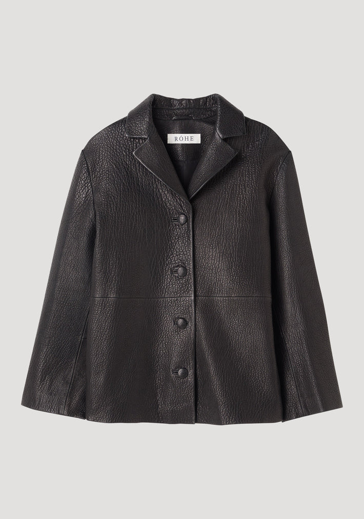 Leather jacket with small lapel in black, featuring a pebbled texture, notch collar, four leather buttons, side-seam pockets, and small side splits. Label reads RÖHE.