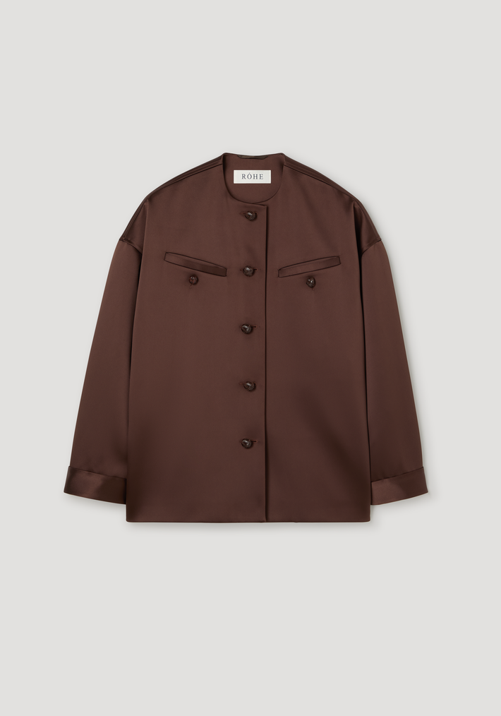 Western heavy satin jacket | espresso: An oversized, collarless jacket with button closure, welted chest pockets, and dropped shoulders, crafted from recycled polyester satin.
