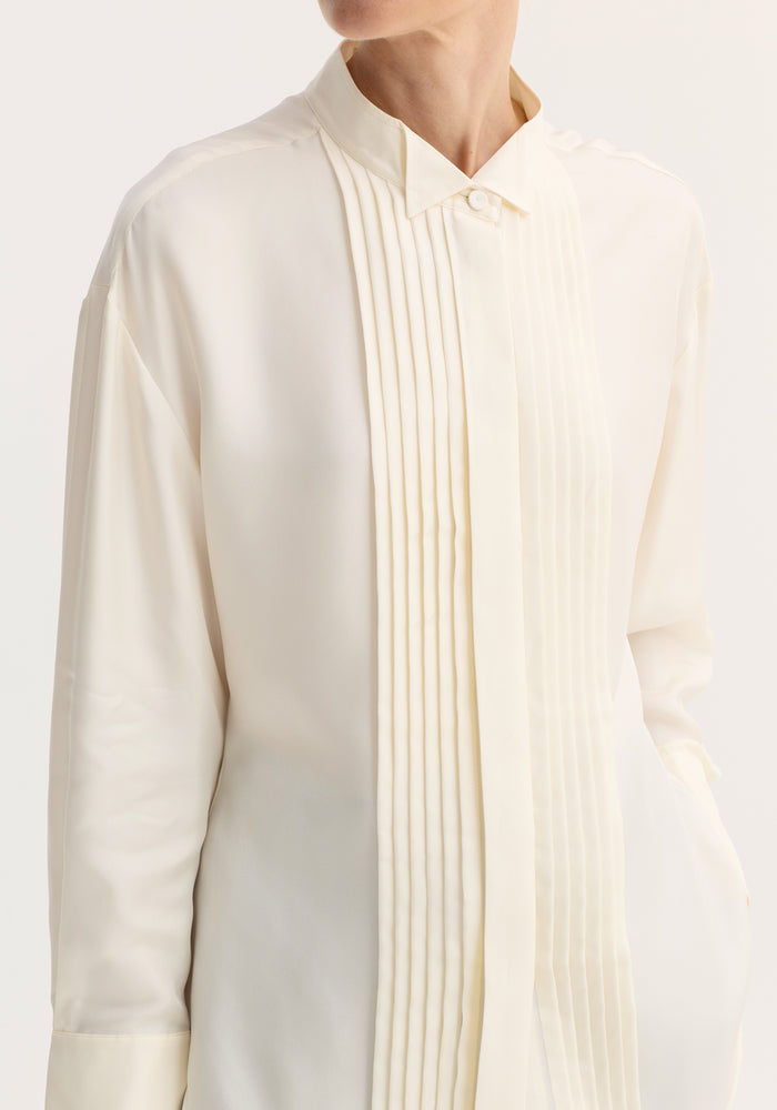 Shaped tuxedo silk shirt in cream, featuring a stand-up collar, pleated front, double cuffs, and hip pocket, crafted from pure silk for an elegant fit.