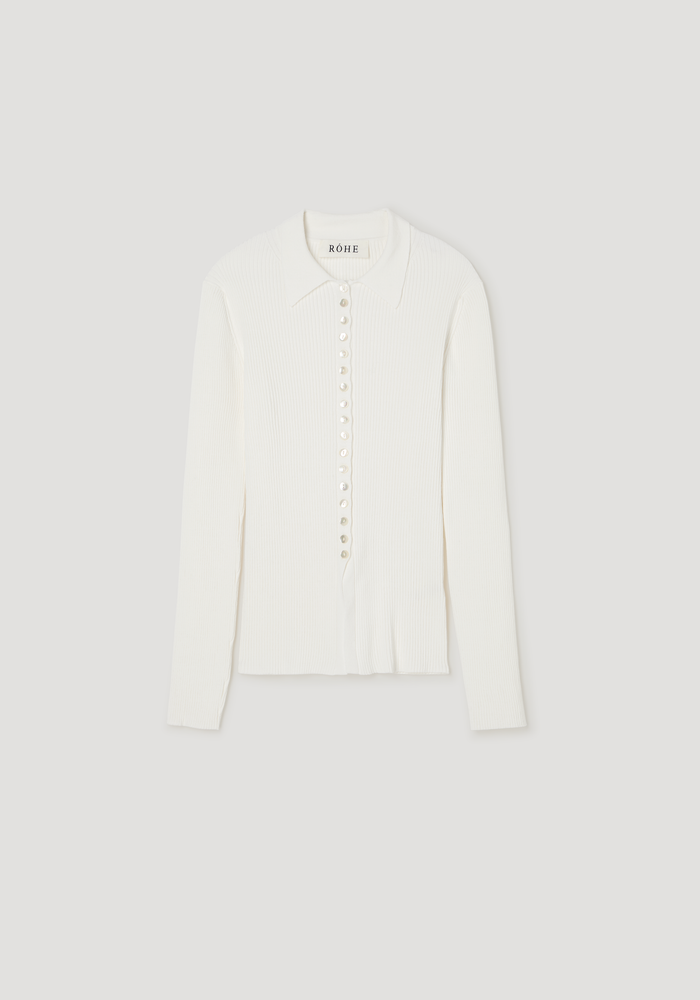 Elongated rib cardigan in off-white with a pointed collar, long sleeves, and mother-of-pearl buttons, showcasing a close-fitting, subtly flared silhouette.
