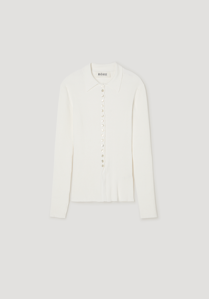 Elongated rib cardigan in off-white with a pointed collar, long sleeves, and mother-of-pearl buttons, showcasing a close-fitting, subtly flared silhouette.