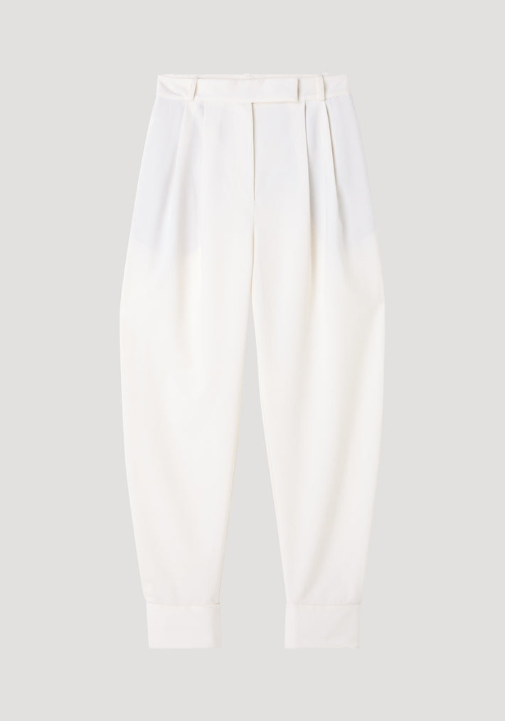 Barrel leg trousers in off white, featuring high-rise, double pleats, and cuffed hems. Crafted from a soft wool blend for a modern silhouette.