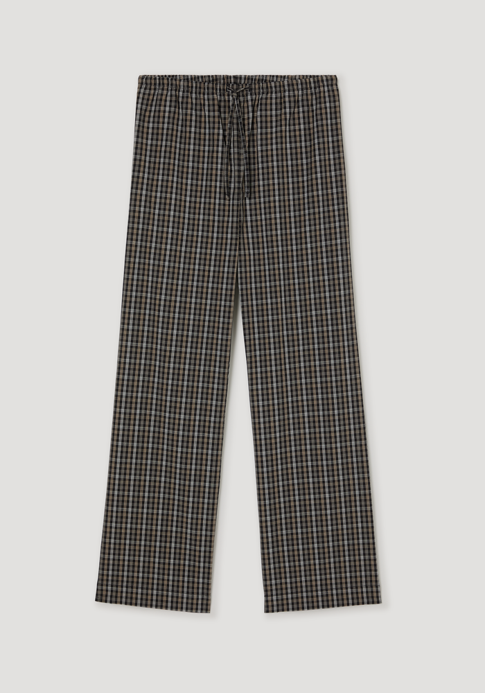 Relaxed fit trousers in black/brown check pattern, full-length with wide legs, elasticated drawstring waistband, and side seam pockets, made from 100% cotton.